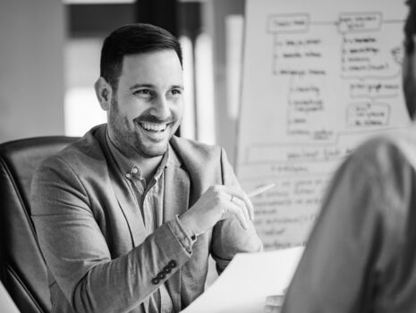 A manager talks to a candidate. Finding applicants has been difficult until now.